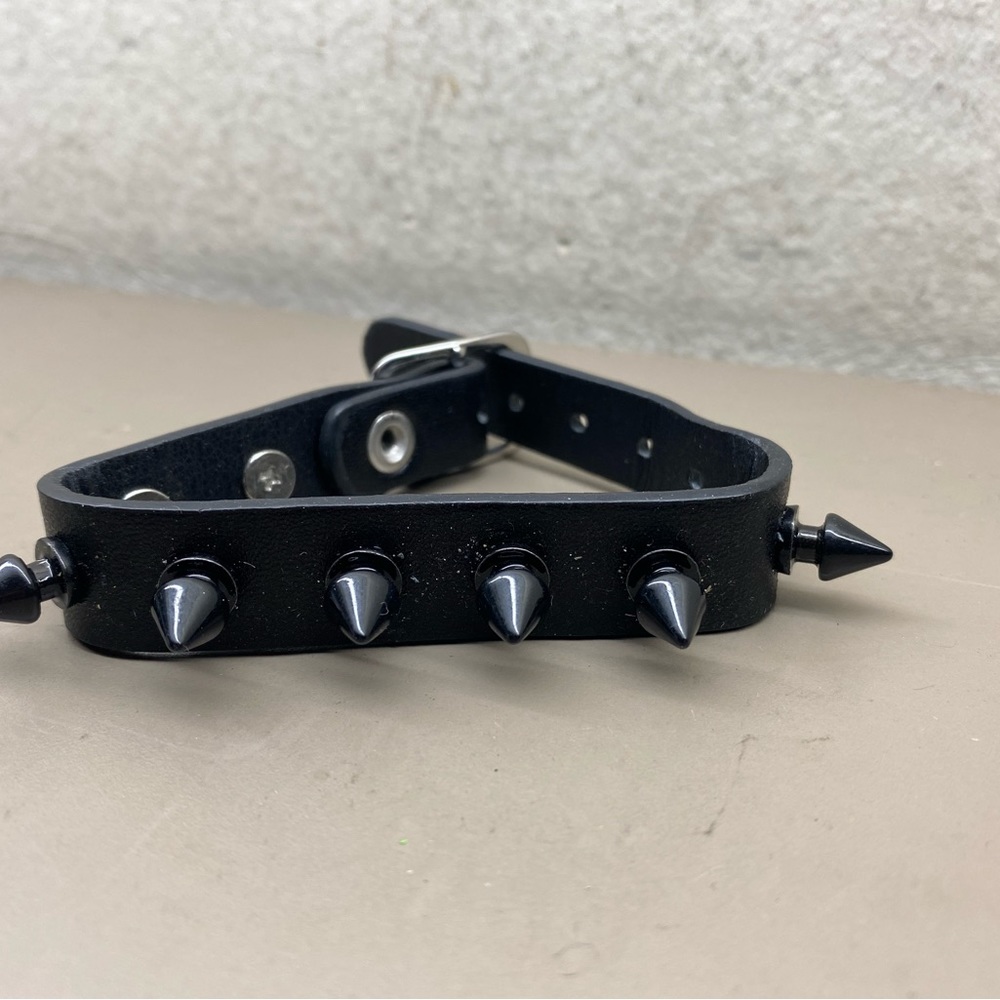 New Unisex Hot Topic Black Polyure Spiked Cuff Bracelet 1/2” wide, 9” long.